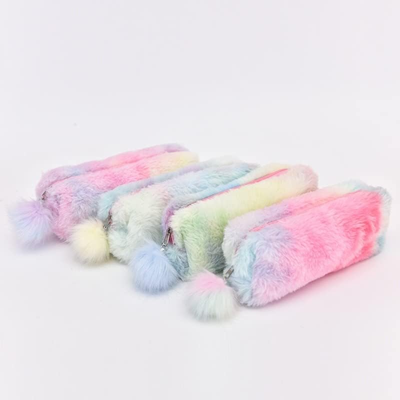 Rainbow plush pencil pouches with fluffy pom‑pom pull tabs in pastel gradient colors (pink, blue, lavender) arranged on a white keyboard and pink desk — cozy, fuzzy aesthetic ideal for stationery and bookish setups.