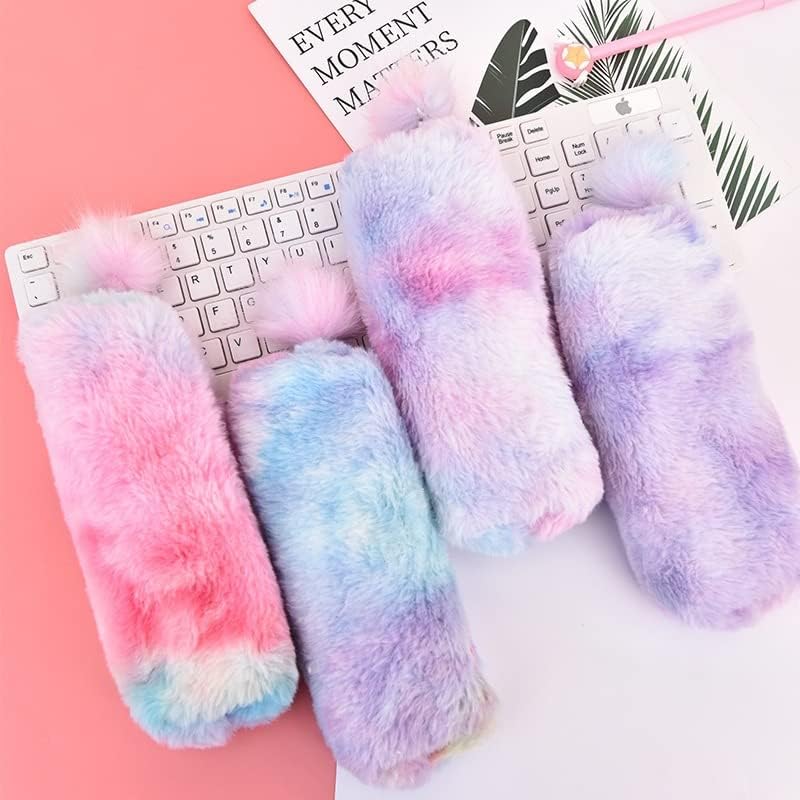 Rainbow plush pencil pouches with fluffy pom‑pom pull tabs in pastel gradient colors (pink, blue, lavender) arranged on a white keyboard and pink desk — cozy, fuzzy aesthetic ideal for stationery and bookish setups.